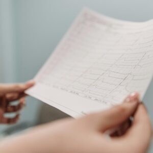 Hands holding a medical test result printout